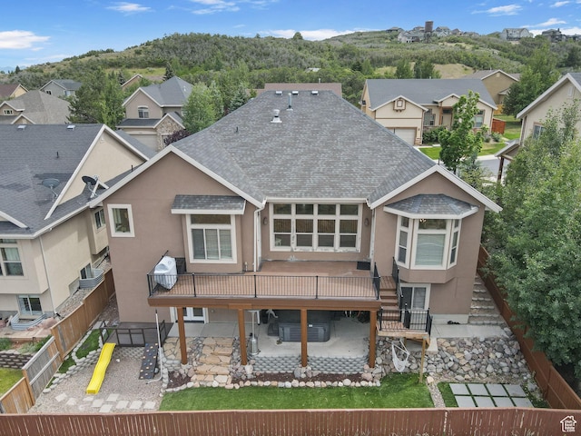 2151 E Village Vista Dr, Draper, UT 84020 - back of property featuring a shingled roof, a patio area, stucco siding, a playground, and a residential view