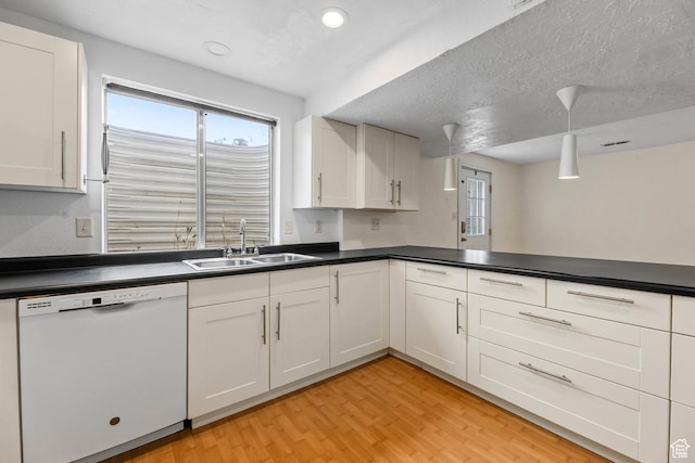9448 S Lady Dove Ln, South Jordan, UT 84095 - kitchen with white dishwasher, dark countertops, light wood finished floors, white cabinets, and recessed lighting