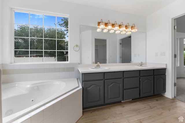 9448 S Lady Dove Ln, South Jordan, UT 84095 - full bathroom featuring double vanity, a whirlpool tub, and wood finished floors