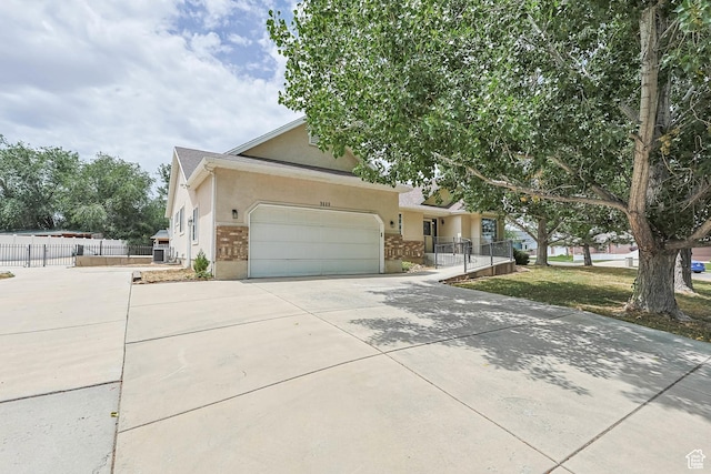9448 S Lady Dove Ln, South Jordan, UT 84095 - view of front of property with stucco siding, a garage, and concrete driveway