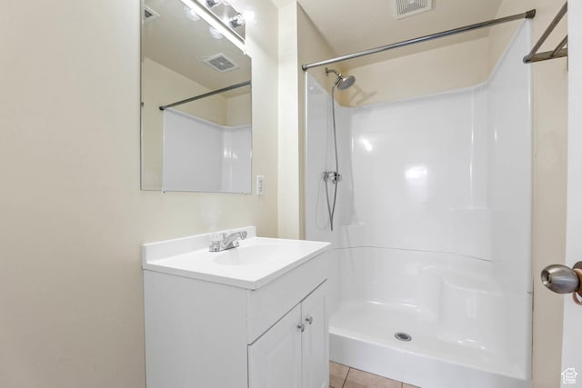 9448 S Lady Dove Ln, South Jordan, UT 84095 - bathroom featuring vanity, a shower, and tile patterned flooring