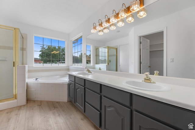 9448 S Lady Dove Ln, South Jordan, UT 84095 - bathroom featuring a stall shower, wood finished floors, double vanity, and a garden tub