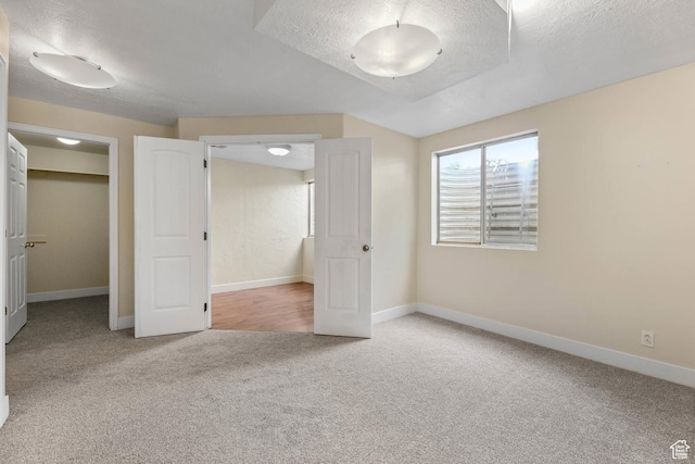 9448 S Lady Dove Ln, South Jordan, UT 84095 - unfurnished bedroom featuring carpet, a textured ceiling, and a spacious closet