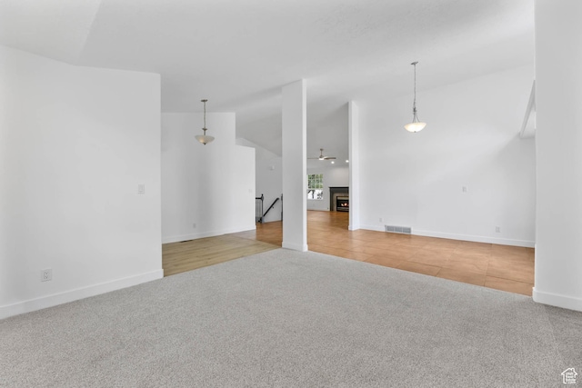 9448 S Lady Dove Ln, South Jordan, UT 84095 - unfurnished living room with carpet flooring and tile patterned flooring