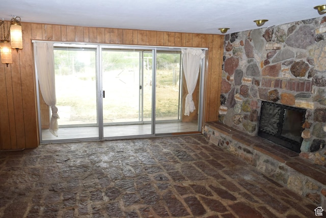 519 Edgehill Pl, East Carbon, UT 84520 - unfurnished living room featuring wooden walls and a fireplace