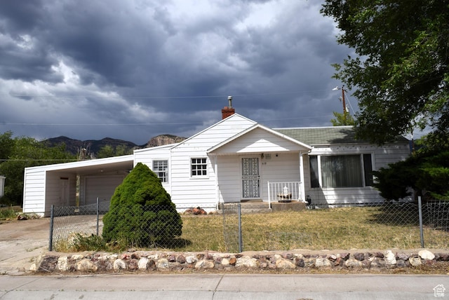 519 Edgehill Pl, East Carbon, UT 84520 - view of front of house featuring driveway, a chimney, an attached carport, and a mountain view