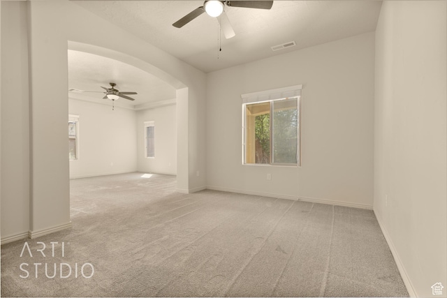 2866 E Carmine Dr, St George, UT 84790 - spare room featuring ceiling fan, carpet floors, and arched walkways