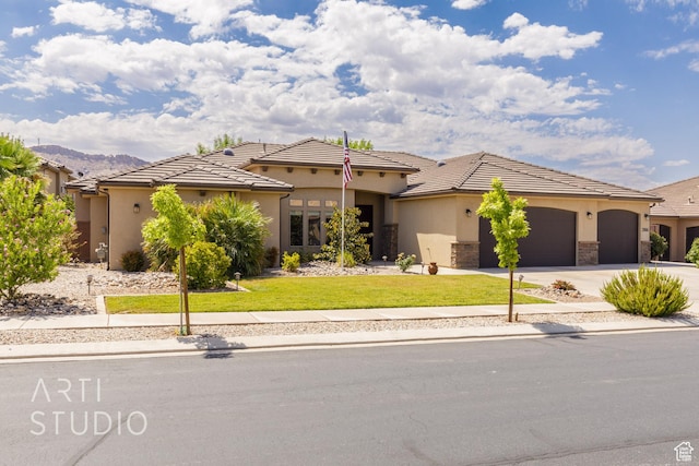 2866 E Carmine Dr, St George, UT 84790 - view of front of house with driveway, an attached garage, a front lawn, and stucco siding