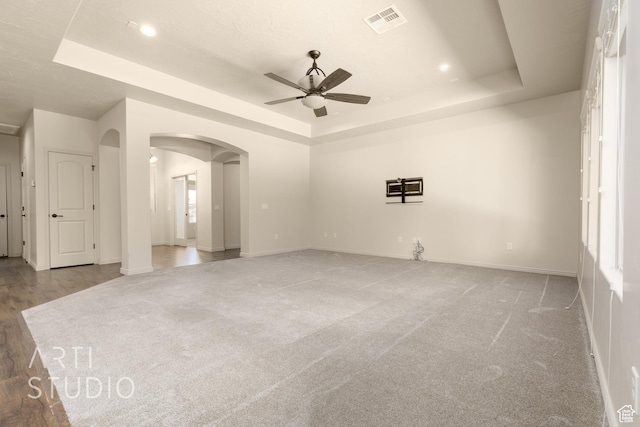 2866 E Carmine Dr, St George, UT 84790 - unfurnished room with a raised ceiling, arched walkways, a ceiling fan, light carpet, and recessed lighting