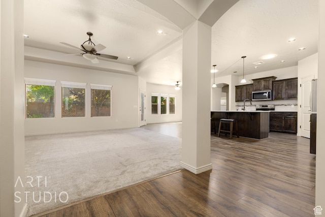 2866 E Carmine Dr, St George, UT 84790 - unfurnished living room featuring ceiling fan, dark wood finished floors, recessed lighting, and arched walkways
