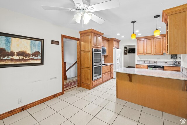 3020 Cherokee Ln, Provo, UT 84604 - kitchen featuring appliances with stainless steel finishes, a peninsula, a ceiling fan, light stone counters, and recessed lighting