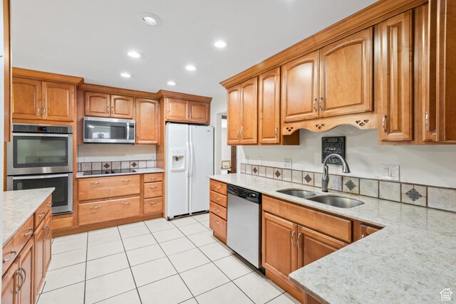 3020 Cherokee Ln, Provo, UT 84604 - kitchen with stainless steel appliances, light stone countertops, recessed lighting, brown cabinets, and light tile patterned flooring