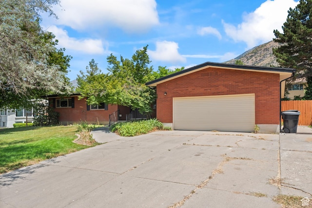3020 Cherokee Ln, Provo, UT 84604 - view of front of house with brick siding, driveway, and a mountain view