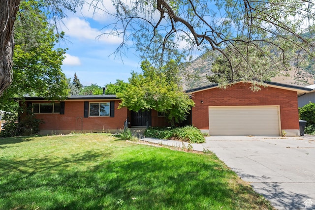 3020 Cherokee Ln, Provo, UT 84604 - ranch-style house with brick siding, driveway, a front lawn, an attached garage, and a mountain view