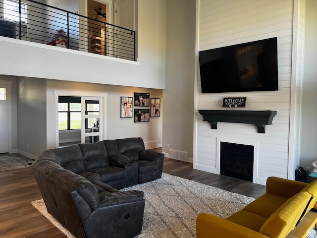 2346 Lake Cir, Preston, ID 83263 - living room with wood finished floors, a high ceiling, a fireplace, and ceiling fan