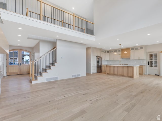 1395 N 330 E Unit 3, Orem, UT 84057 - unfurnished living room with french doors, a towering ceiling, stairs, light wood finished floors, and recessed lighting
