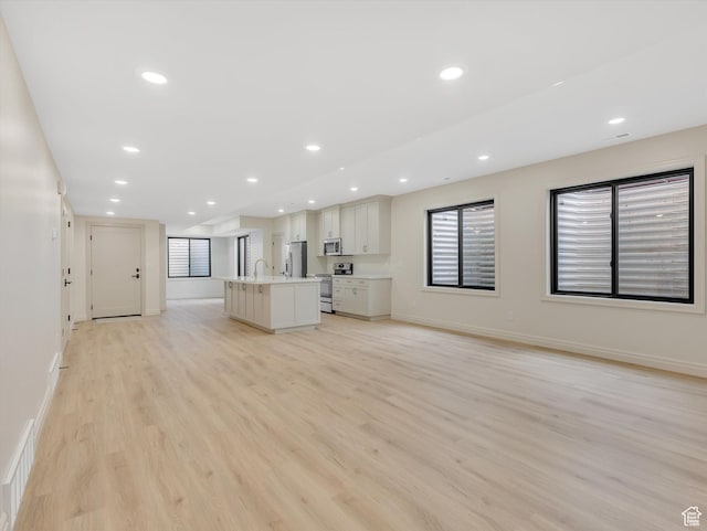 1395 N 330 E Unit 3, Orem, UT 84057 - unfurnished living room with light wood-type flooring, healthy amount of natural light, and recessed lighting