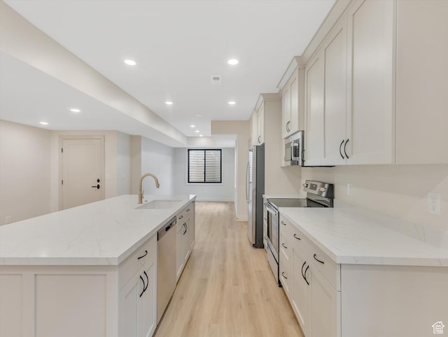 1395 N 330 E Unit 3, Orem, UT 84057 - kitchen featuring stainless steel appliances, an island with sink, light wood-style floors, recessed lighting, and light stone counters