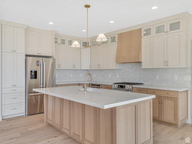 1395 N 330 E Unit 3, Orem, UT 84057 - kitchen with appliances with stainless steel finishes, custom range hood, light wood-style flooring, an island with sink, and tasteful backsplash