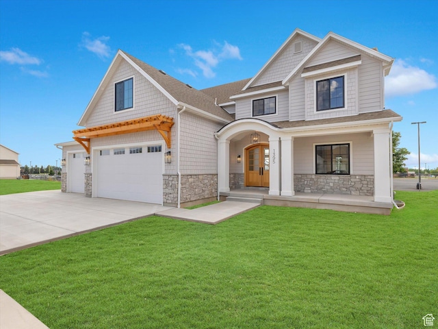 1395 N 330 E Unit 3, Orem, UT 84057 - craftsman house featuring stone siding, a front lawn, driveway, covered porch, and a shingled roof