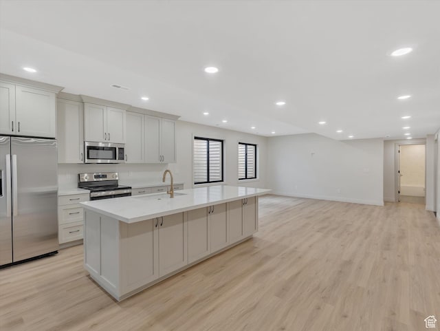 1395 N 330 E Unit 3, Orem, UT 84057 - kitchen featuring appliances with stainless steel finishes, an island with sink, light wood-style flooring, recessed lighting, and open floor plan