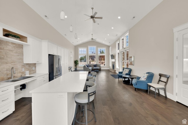 10376 S Beetdigger Blvd, Sandy, UT 84070 - kitchen featuring stainless steel fridge with ice dispenser, a ceiling fan, open floor plan, high vaulted ceiling, and a center island
