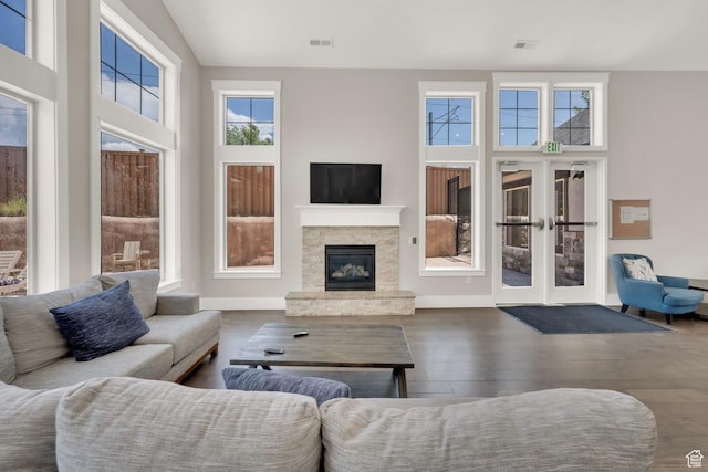 10376 S Beetdigger Blvd, Sandy, UT 84070 - living room with wood finished floors, a stone fireplace, a towering ceiling, and french doors