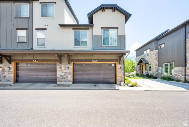 10376 S Beetdigger Blvd, Sandy, UT 84070 - townhome / multi-family property featuring stone siding, an attached garage, and board and batten siding