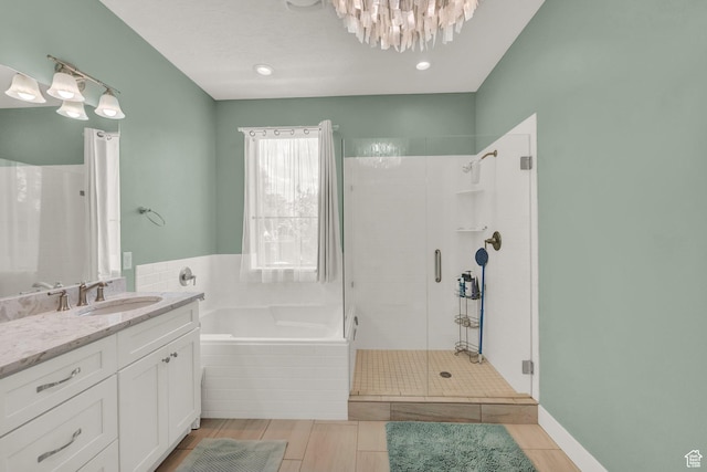 10376 S Beetdigger Blvd, Sandy, UT 84070 - bathroom featuring a stall shower, a garden tub, vanity, and a chandelier