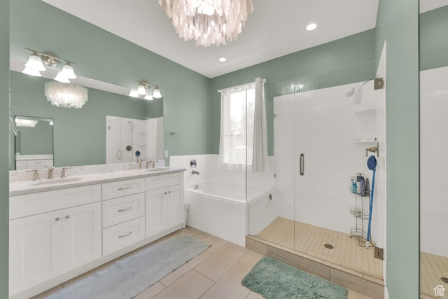 10376 S Beetdigger Blvd, Sandy, UT 84070 - bathroom with a chandelier, a shower stall, a garden tub, double vanity, and recessed lighting