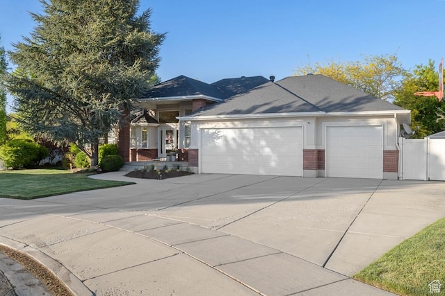 10025 Silver Streak Dr, South Jordan, UT 84095 - single story home featuring concrete driveway, an attached garage, brick siding, and a gate