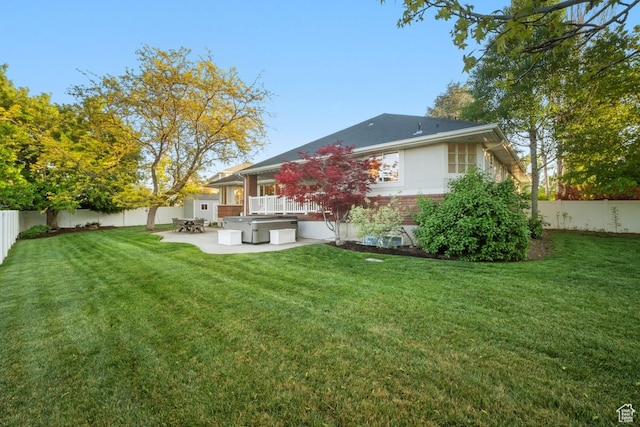 10025 Silver Streak Dr, South Jordan, UT 84095 - rear view of house with a hot tub, a patio, and a fenced backyard