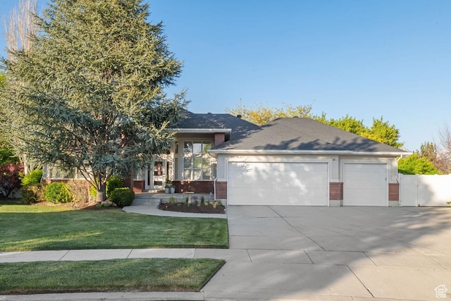 10025 Silver Streak Dr, South Jordan, UT 84095 - view of front of house featuring driveway, a garage, brick siding, and a gate