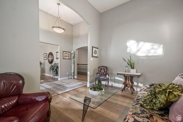 10025 Silver Streak Dr, South Jordan, UT 84095 - living area with arched walkways, hardwood / wood-style flooring, and a high ceiling
