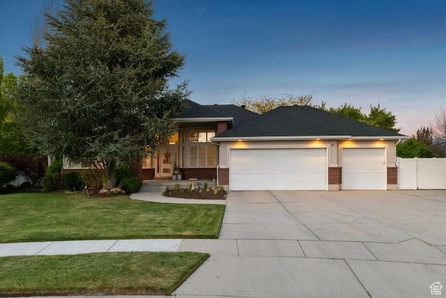 10025 Silver Streak Dr, South Jordan, UT 84095 - view of front of property with a garage, concrete driveway, and brick siding