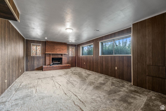 8614 S Buena Vista Dr E, Sandy, UT 84094 - unfurnished living room with carpet, wooden walls, and a brick fireplace