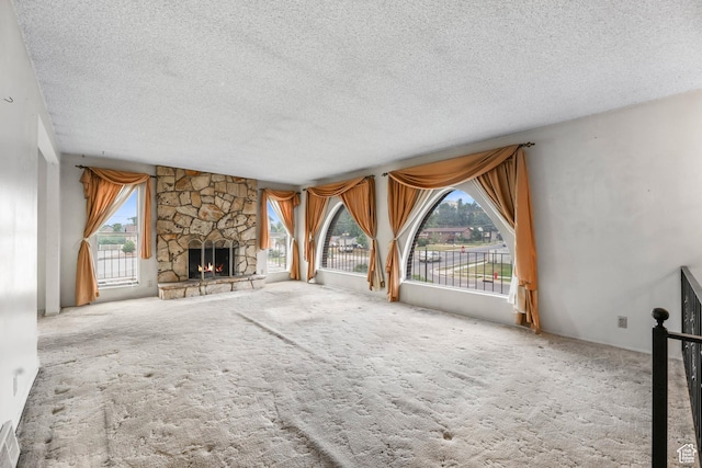 8614 S Buena Vista Dr E, Sandy, UT 84094 - unfurnished living room featuring a textured ceiling, a stone fireplace, and carpet floors