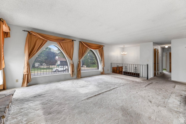 8614 S Buena Vista Dr E, Sandy, UT 84094 - unfurnished living room featuring a chandelier, a textured ceiling, and carpet flooring