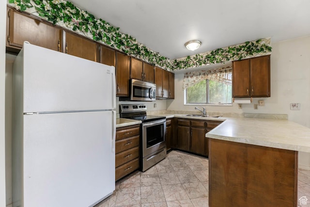 8614 S Buena Vista Dr E, Sandy, UT 84094 - kitchen with stainless steel appliances, a peninsula, light countertops, and light marble finish floors