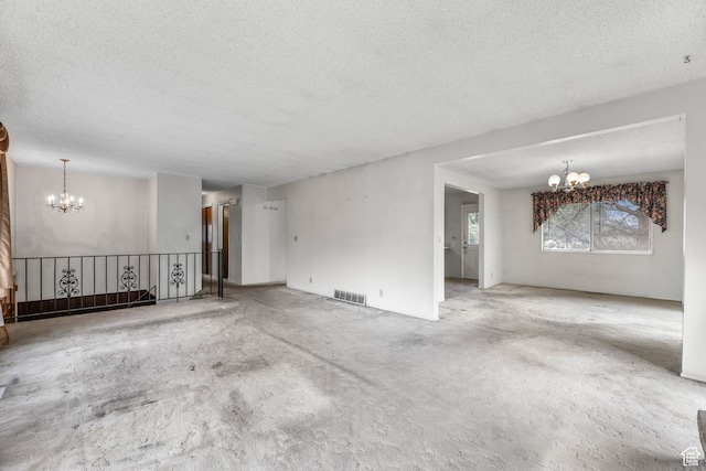 8614 S Buena Vista Dr E, Sandy, UT 84094 - unfurnished living room featuring a chandelier, a textured ceiling, and carpet floors