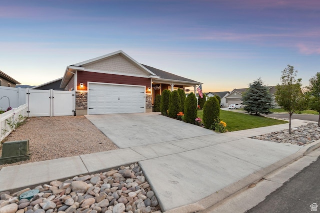 644 E 780 S, Heber City, UT 84032 - view of front facade featuring a gate, an attached garage, concrete driveway, and stone siding