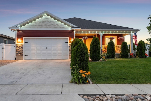 644 E 780 S, Heber City, UT 84032 - view of front of home featuring driveway, an attached garage, stone siding, a gate, and a porch