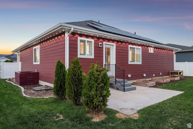 644 E 780 S, Heber City, UT 84032 - back of property at dusk featuring roof mounted solar panels and a patio