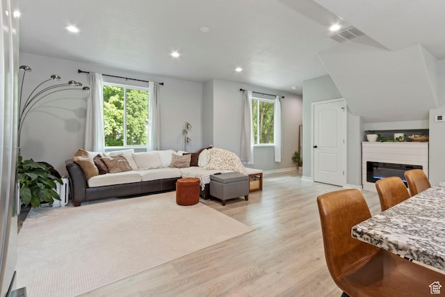 1288 Lincoln Ave, Ogden, UT 84404 - living area featuring light wood-type flooring, healthy amount of natural light, recessed lighting, and a glass covered fireplace