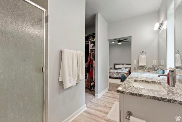 1288 Lincoln Ave, Ogden, UT 84404 - ensuite bathroom with a shower stall, double vanity, wood finished floors, ceiling fan, and a spacious closet