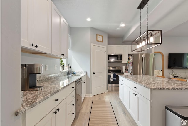 1288 Lincoln Ave, Ogden, UT 84404 - kitchen featuring stainless steel appliances, light wood-type flooring, white cabinets, light stone counters, and recessed lighting