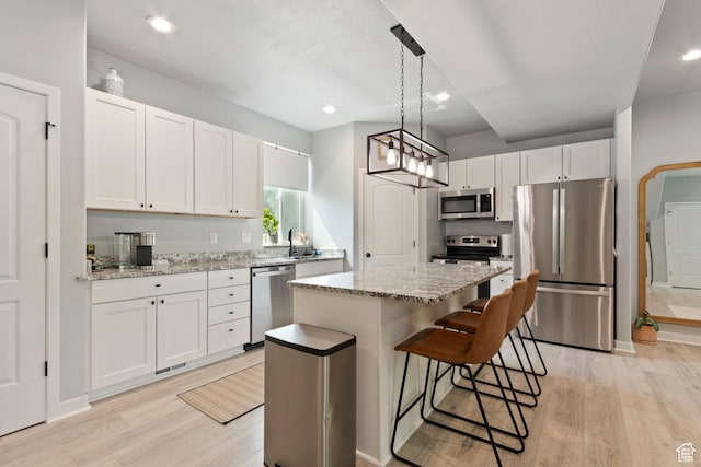 1288 Lincoln Ave, Ogden, UT 84404 - kitchen featuring stainless steel appliances, light wood-type flooring, a kitchen island, white cabinetry, and recessed lighting