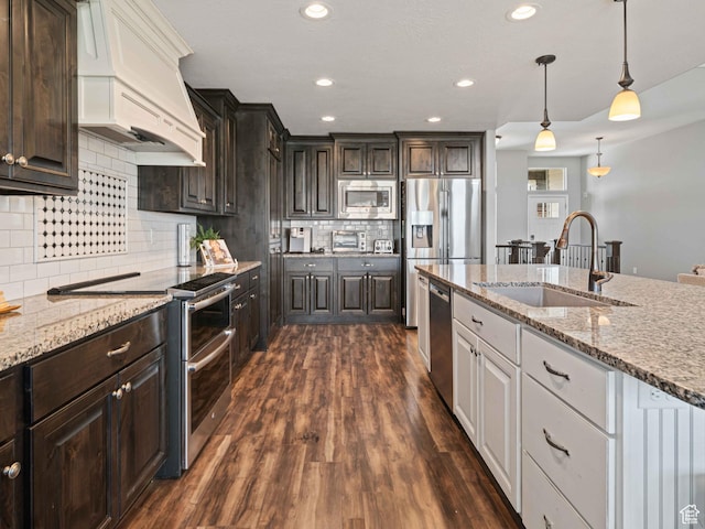 3552 S 5250 W Unit 13, Hooper, UT 84315 - kitchen featuring appliances with stainless steel finishes, dark brown cabinets, white cabinets, dark wood-style flooring, and light stone countertops