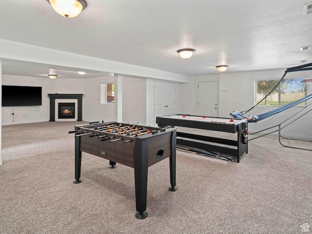 3552 S 5250 W Unit 13, Hooper, UT 84315 - recreation room with carpet flooring, a textured ceiling, and a warm lit fireplace