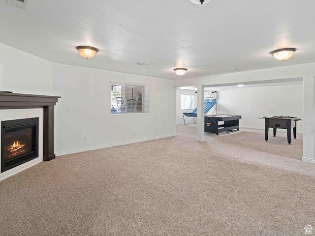 3552 S 5250 W Unit 13, Hooper, UT 84315 - carpeted living area featuring a glass covered fireplace and a textured ceiling